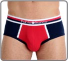 Sporty, solid cotton material, colors red and blue marine. Blue, white and red striped waist band. Center logo. Lined at the front.